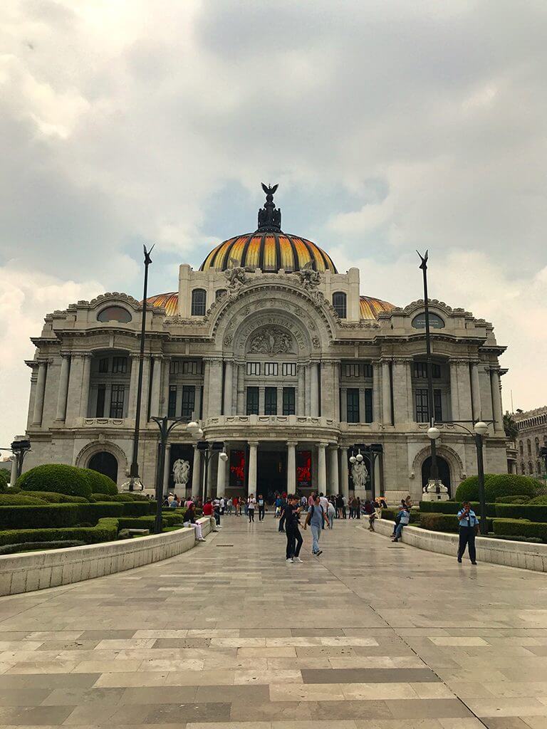 visitors walk out of the Palacio de Bellas Artes, a must-see in Mexico City