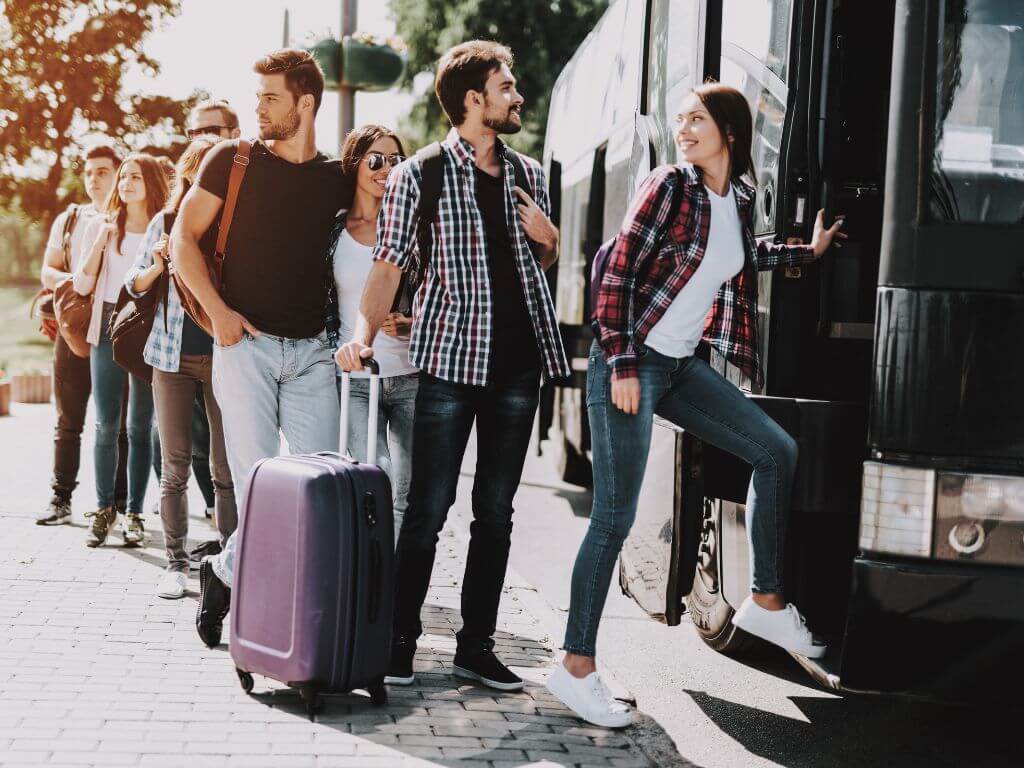 passengers boarding a bus with their luggage