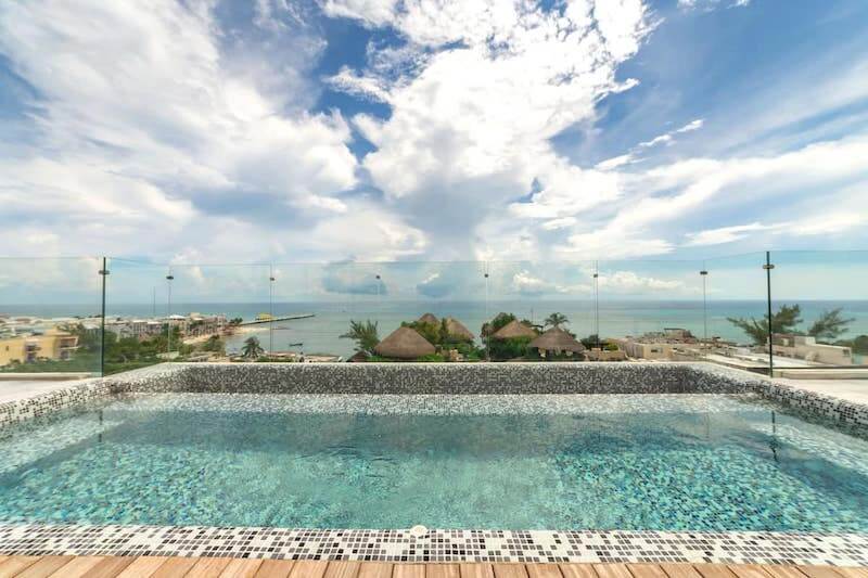 looking across rooftop pool to view of the caribbean sea from a playa del carmen airbnb