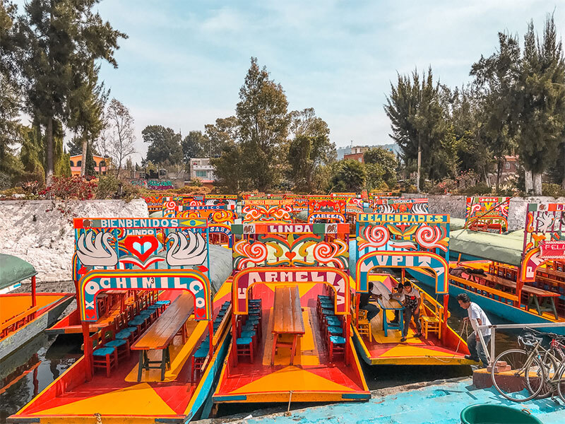 Trajinera boats are all sandwiched into the dock in Xochimilco