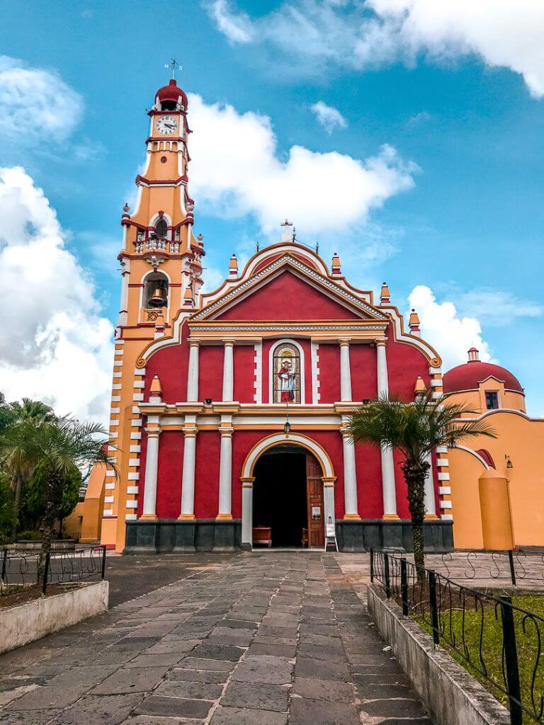 yellow and red cathedral in coatepec, mexico