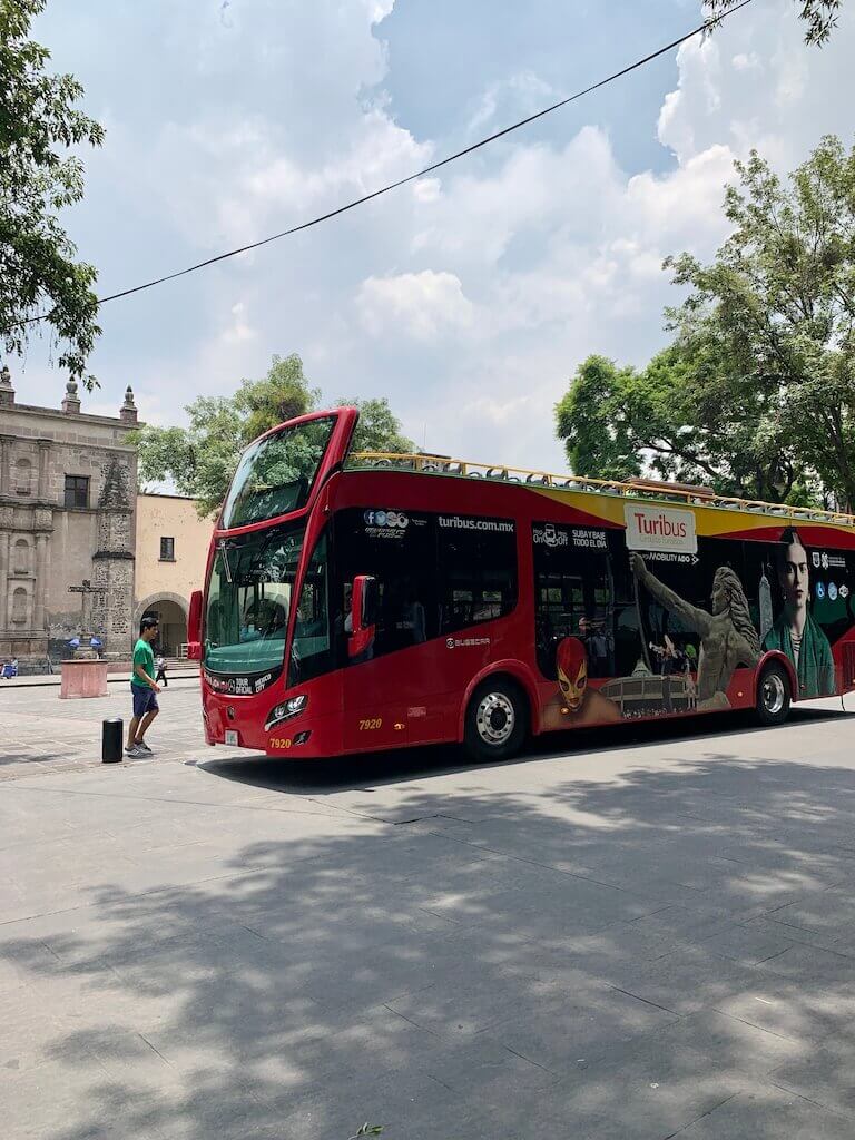 A bright red double-decker Turibus tours around Mexico City, offering passengers a chance to explore the city at their leisure.