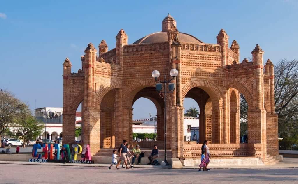 A Mexican family walks by La Pila, a Moorish-style fountain in Chiapa de Corzo, a must-see attraction in Chiapas