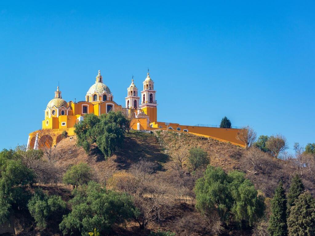 Cholula's famous cathedral, Nuestra Señora de los Remedios, sits on top of the world's largest pyramid, which is only partially excavated.