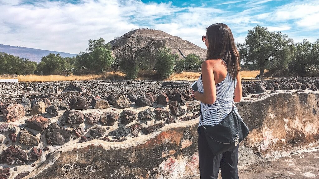 A woman admires the pyramid of the sun at Teotihuacan on a day trip from Mexico City