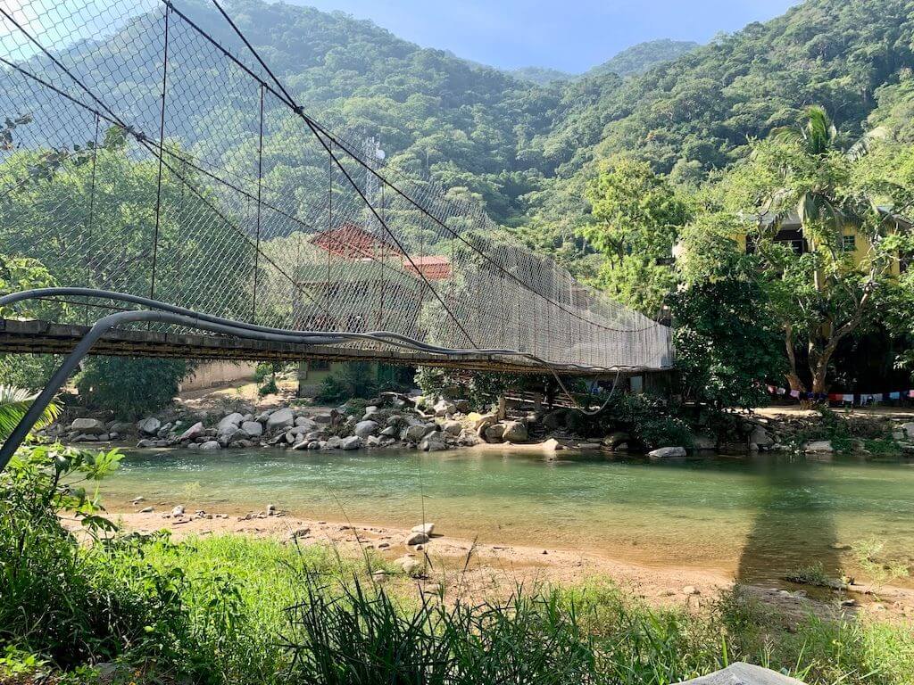 foot bridge spanning the Tomatlan river that leads to the hike toward Las Animas Beach