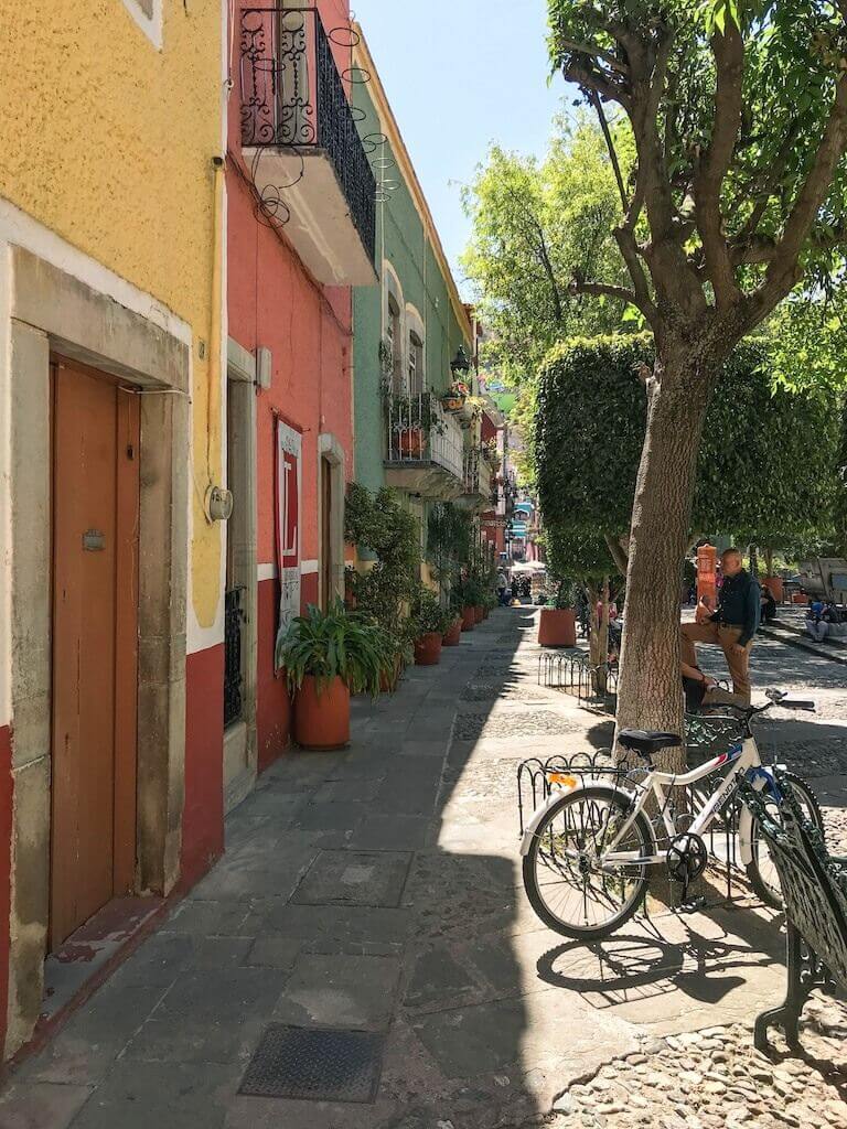 colorful buildings line a cobblestone plaza in Guanajuato City, Mexico