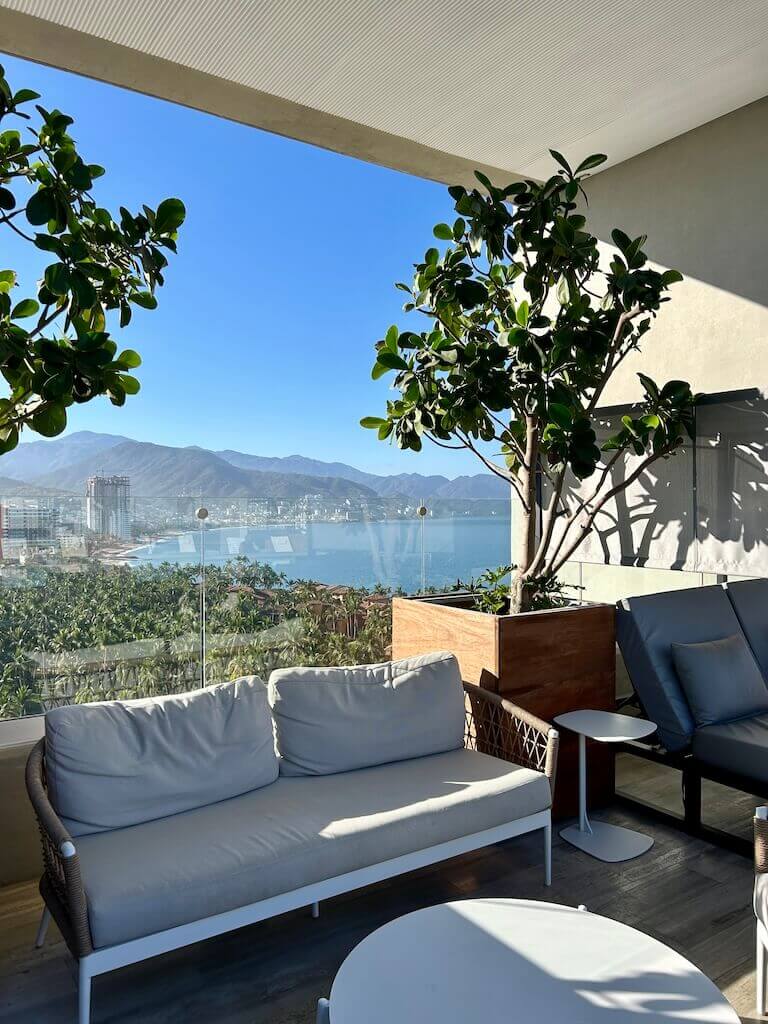 shaded sofa on the Hotel Mio rooftop with view of the ocean behind