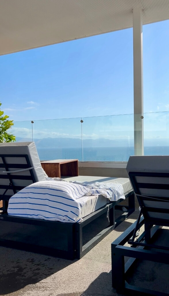 a pool lounger on the Hotel Mio Vallarta rooftop looks out over Banderas Bay