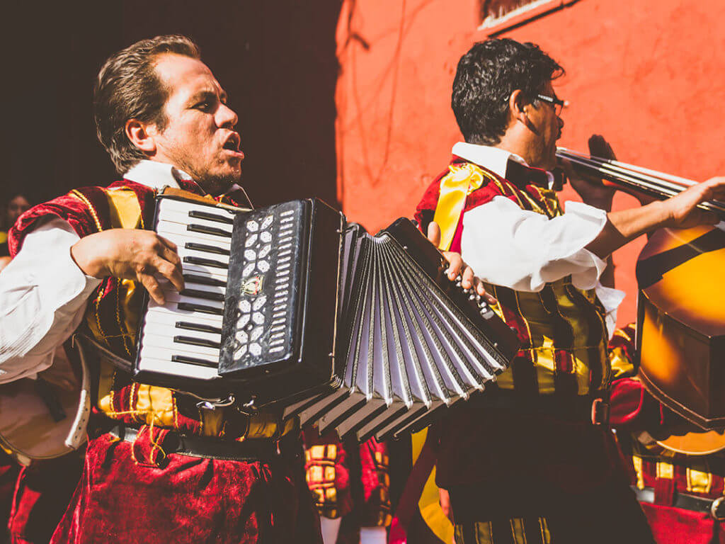 street musicians performing in mexico, one is playing the accordion and the other a stand-up bass