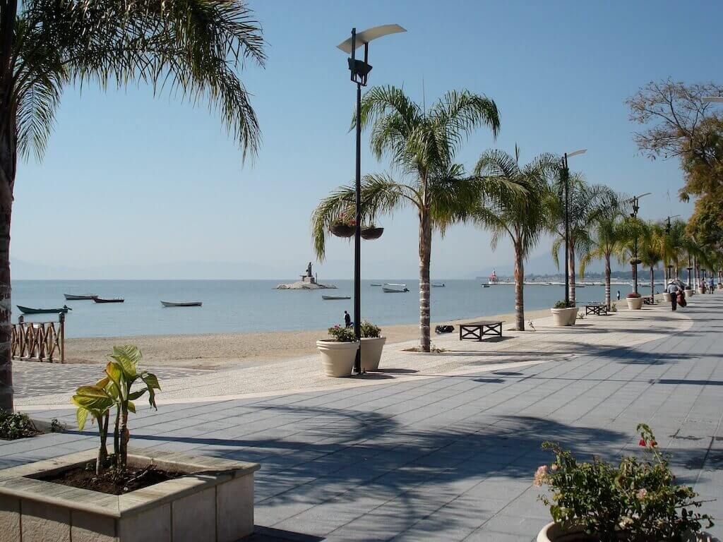 view looking down the palm-tree lined malecon alongside Lake Chapala in Jalisco, Mexico