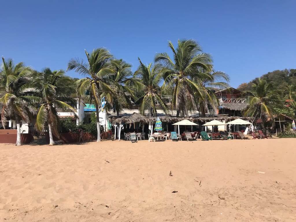 beach chairs in the sand in Mazunte, Oaxaca, one of the best beach places in Mexico