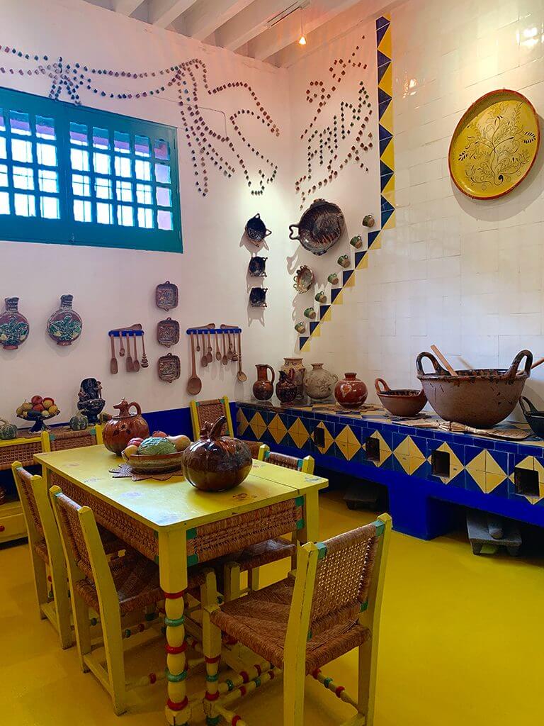 The yellow, blue, and white kitchen at Frida Kahlo's Casa Azul, Mexico City