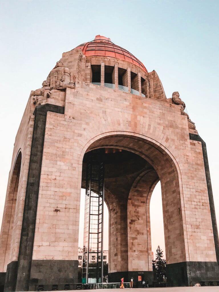 photo looking up at the monument to the revolution in Mexico City