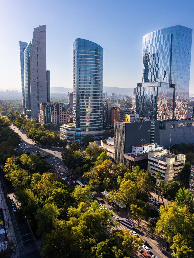 Aerial view of the Paseo de la Reforma avenue in Mexico City, with modern high-rises along the street