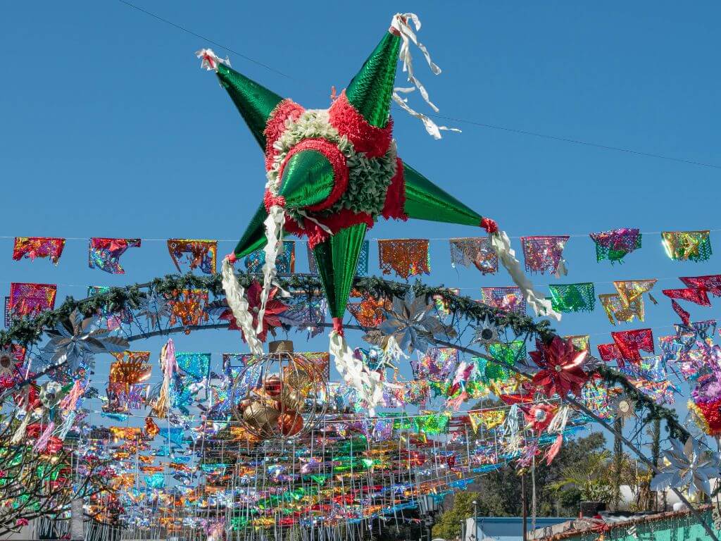 piñata hanging with papel picado in the background