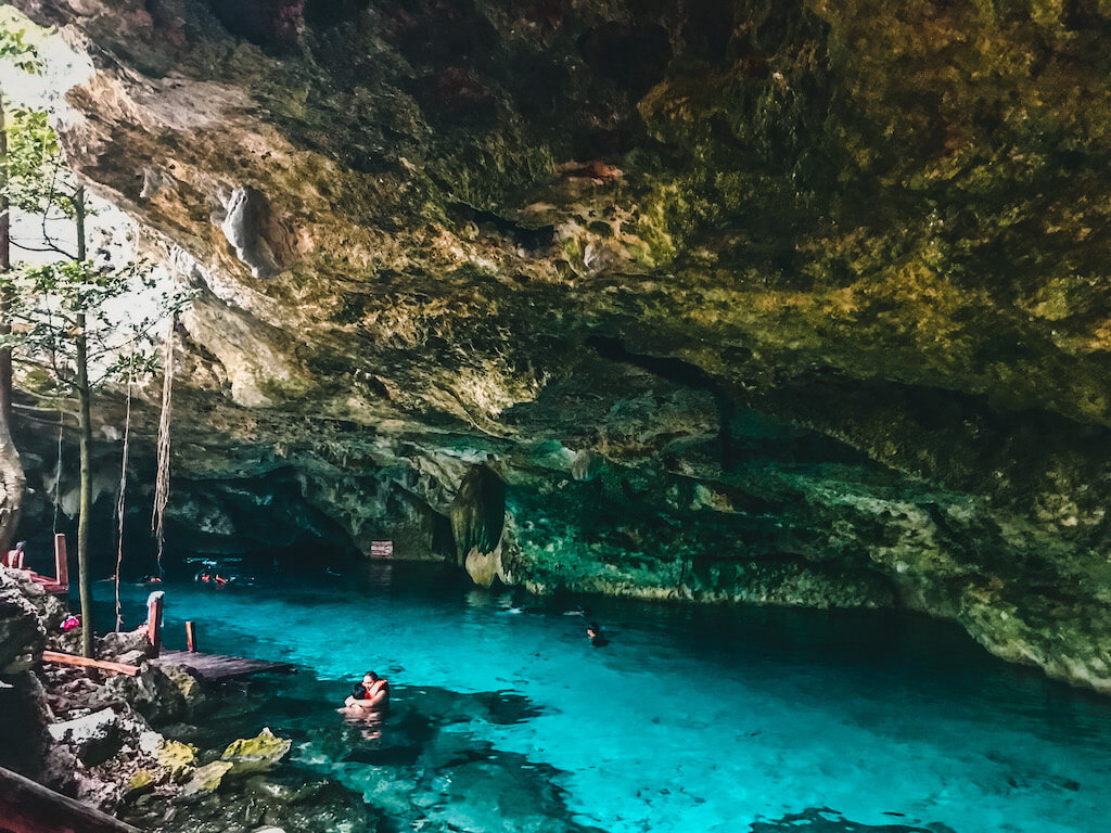 swimmers frolic in the water at dos ojos cenote