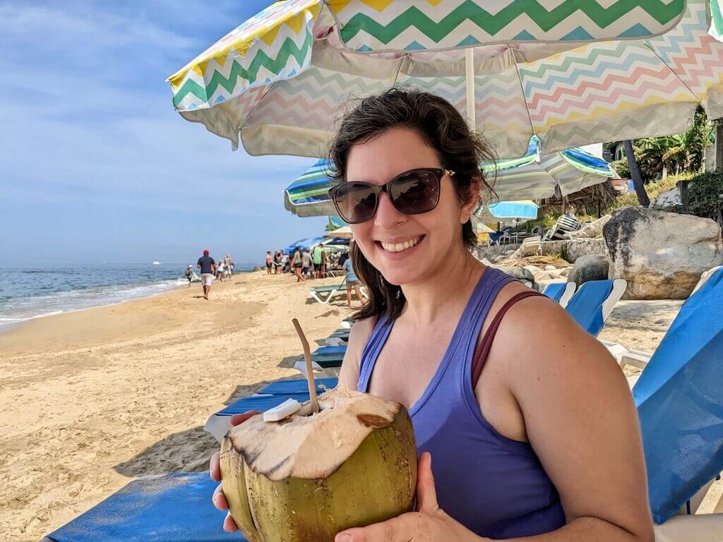 Janine  enjoying a cold coconut on the beach in Puerto Vallarta 