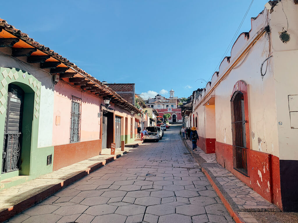 view down a cobblestone street in San Cristobal de Las Casas, Chiapas, Mexico