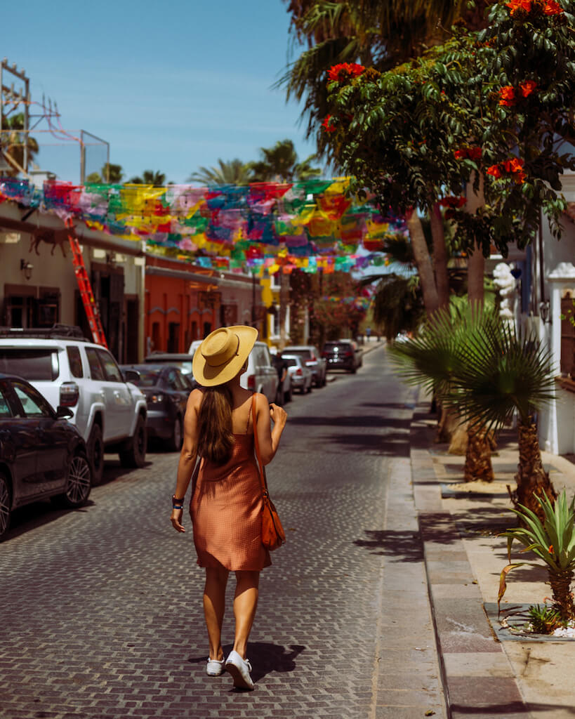 woman walking alone down the street in San Jose del Cabo, Mexico