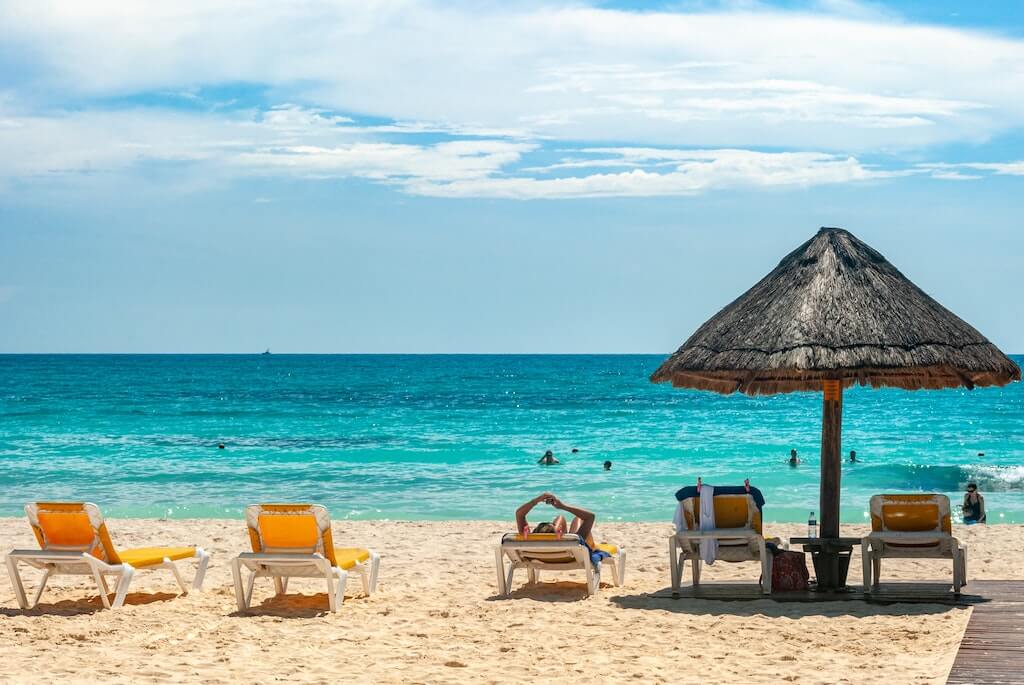 beach chairs in the sand on a beach in Cancun, Mexico