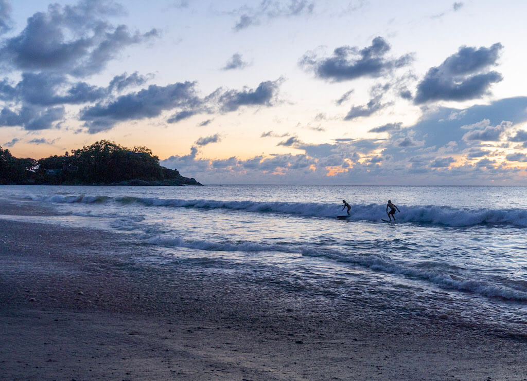 two surfers in Sayulita, Mexico at sunset