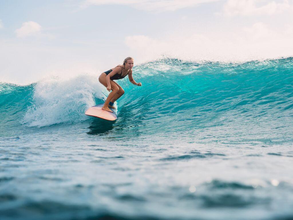 blonde woman surfing a long board near Puerto Vallarta