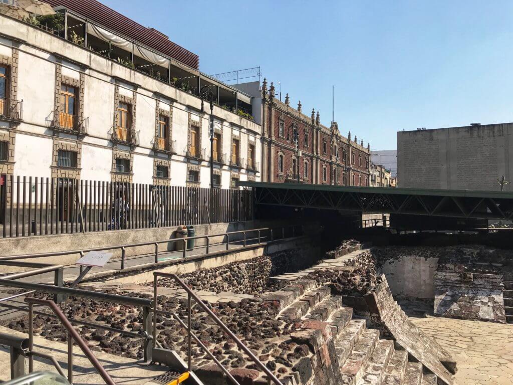 the templo de mayor ruins in Centro Historico Mexico City with colonial buildings in the background