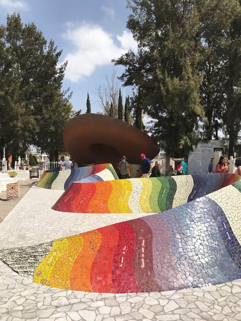 The mausoleum for the mexican musican Jose Alfredo features an enormous sombrero with a rainbow mosaic emerging from beneath it